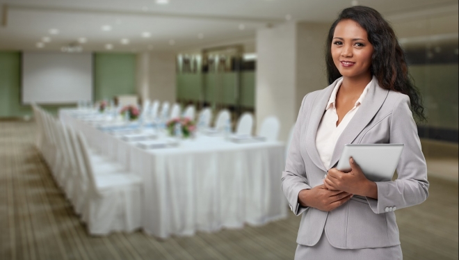  Conference Coordinator standing at table